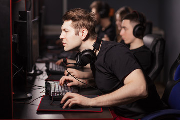 Casual gamers and hardcore fans are gather together in pc gaming club to compete in playing MMO Games online Tournament