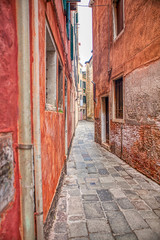Fototapeta na wymiar walking along narrow and old Italian street 