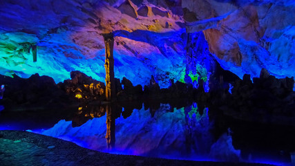Fototapeta na wymiar Colorful light show at Reed Flute Cave
