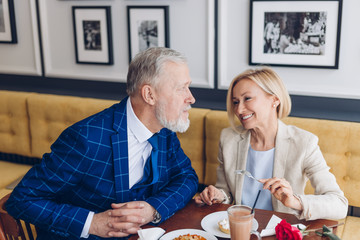 funny smart man flirting with his woman. family having fun at the restaurant. close up portrait