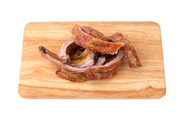 Smoked ribs on a white background. Smoked ribs on a wooden board isolated on white background.
