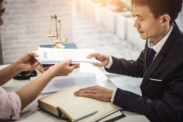 Male lawyer explain a contract agreement to client for law .Law and Legal services concept.