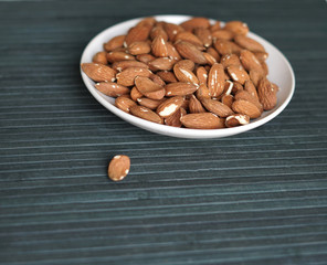 Healthy food  for background image close up almond nuts. Texture Nuts on the cup plate