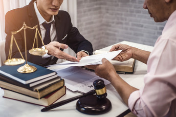 Male lawyer explain a contract agreement to client for law .Law and Legal services concept.