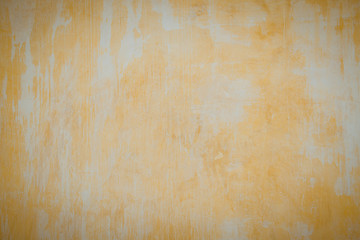 Old plaster walls painted gold. Texture of the wall.