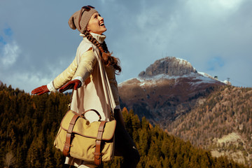 Fototapeta premium traveller woman against mountain scenery rejoicing