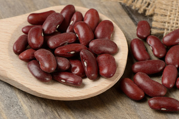 Long purple bean in a wooden spoon