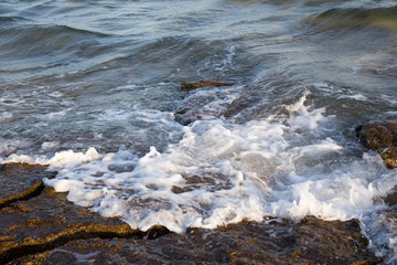 Beautiful coastline with stones and water. blue sea wave photograph close up. vacation at sea or ocean. Background to insert images and text. Tourism, travel.