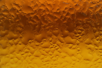 Condensation on the amber and gold color gradation glass bottle