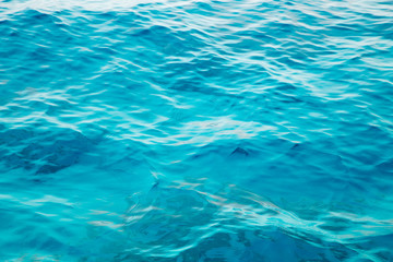 Blue clear water. Beautiful blue sea wave photograph close up. Beach vacation at sea or ocean. Background to insert images and text. Tourism, travel.