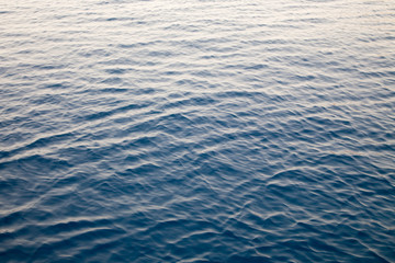 Blue clear water. Beautiful blue sea wave photograph close up. Beach vacation at sea or ocean. Background to insert images and text. Tourism, travel.