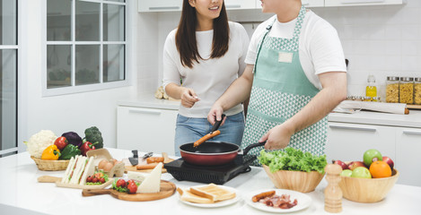 Young couple cooking together