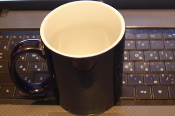 Mug on the laptop keyboard