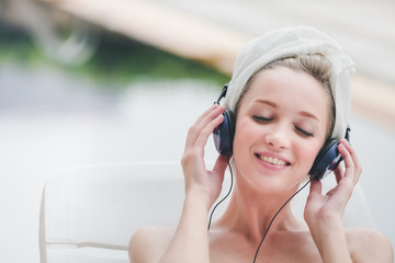 Woman pool spa with headphone concept