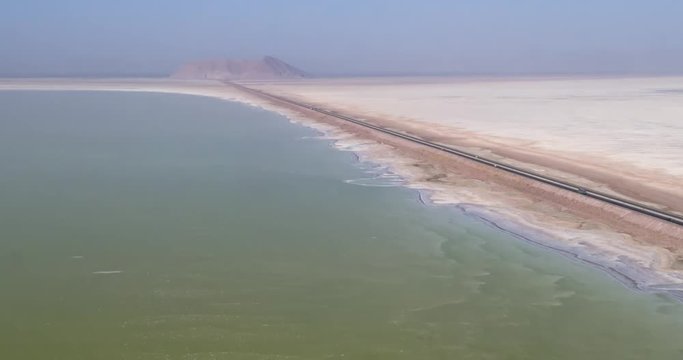 Aerial photography. From a bird's eye view of the road that crosses the salty lake Urmia, Iran. 4k.