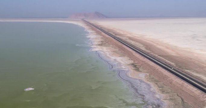 Aerial photography. From a bird's eye view of the road that crosses the salty lake Urmia, Iran. 4k.