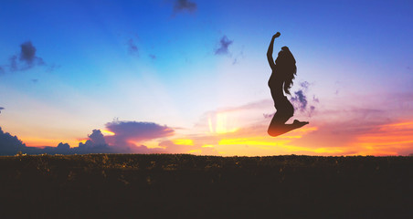 Silhouette of happy travel woman jumping