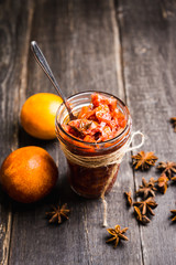 Glass jar with freshly maked orange jam. Selective focus. Shallow depth of field.