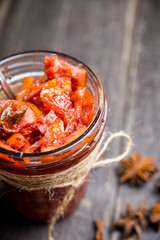 Glass jar with freshly maked orange jam. Selective focus. Shallow depth of field.