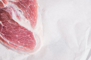 Raw pork meat with salt and spices on the rustic background. Selective focus. 