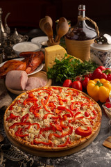 Pizza with ham, chicken and paprika