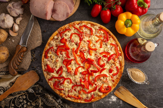 Pizza with ham, chicken and paprika