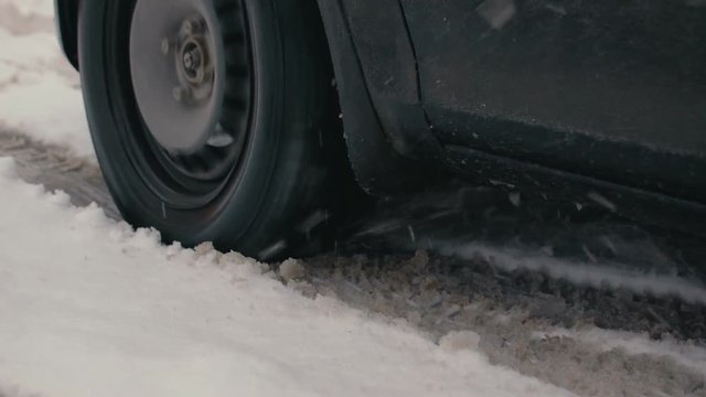 Passenger car stuck in a snowdrift. Wheel slip Close-up