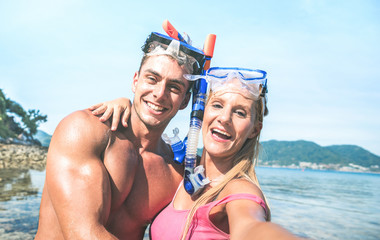 Young happy couple in love taking selfie in tropical excursion with water camera - Boat trip...