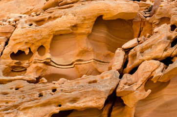 texture of orange stone rock in a colored canyon close up