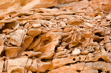 texture of orange stone rock in a colored canyon close up