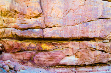 texture of orange stone rock in a colored canyon close up