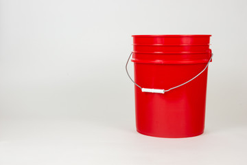 Isolated red bucket on white background.