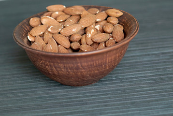 Healthy food  for background image close up almond nuts. Texture Nuts on the cup plate
