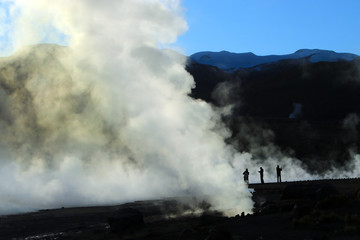 Fototapeta na wymiar People walking in the smoke of the geysers in el tatio atacama