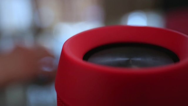 Close-up on bluetooth speakers and female hand with smartphone.