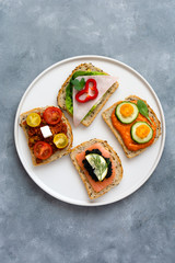 Breakfast toasts with various toppings. Healthy bruschetta. Bread sandwich.