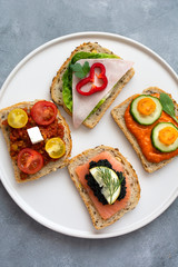 Breakfast toasts with various toppings. Healthy bruschetta. Bread sandwich.