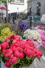 Friendly flower vendors sell large bouquets of bright fresh flowers at the downtown farmer's market.