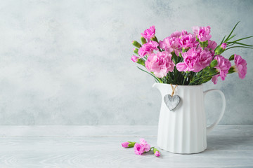 Mother's day background with flowers and heart shape on wooden table