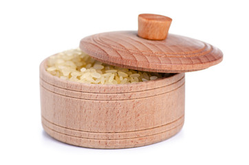 Rice in wooden bowl with lid on white background isolation