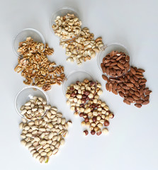 Healthy food. Nuts mix assortment on stone table top view. Collection of different legumes for background image close up nuts, pistachios, almond, cashew nuts, peanut, walnut. image