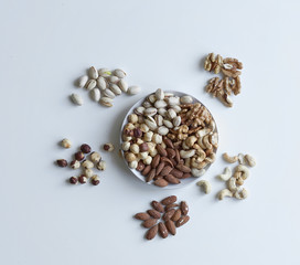 Healthy food. Nuts mix assortment on stone table top view. Collection of different legumes for background image close up nuts, pistachios, almond, cashew nuts, peanut, walnut. image