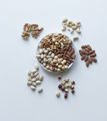 Healthy food. Nuts mix assortment on stone table top view. Collection of different legumes for background image close up nuts, pistachios, almond, cashew nuts, peanut, walnut. image