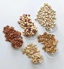 Healthy food. Nuts mix assortment on stone table top view. Collection of different legumes for background image close up nuts, pistachios, almond, cashew nuts, peanut, walnut. image