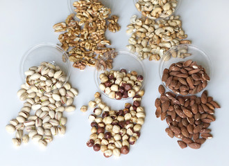 Healthy food. Nuts mix assortment on stone table top view. Collection of different legumes for background image close up nuts, pistachios, almond, cashew nuts, peanut, walnut. image