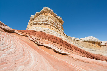 Colorful sandstone with blue sky at White Pocket in the Vermillion Cliffs National Monument, Arizona, USA.