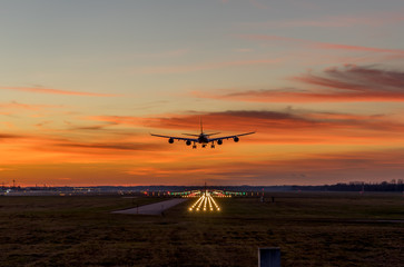 landing airplane during sunset
