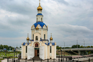 Fototapeta na wymiar Russian Orthodox Church of St. Archangel Gabriel on the campus of the National Belgorod University. Orthodox church golden domes and crosses