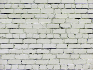 rough white cilicate brickwork wall with cracks