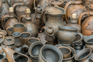 Clay dishes. Ceramic national Ukrainian dishes made in the Poltava region in the village of Opishnya and demonstrated at the in Velyki Sorochyntsi Fair. Burnt black ceramics. Burned clay jars